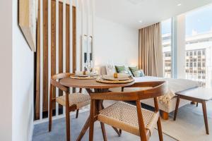 a dining room with a table and a bed at Timeless Studio - Avenida in Aveiro