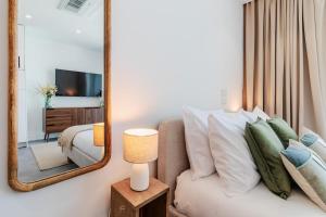 a hotel room with a bed and a mirror at Timeless Studio - Avenida in Aveiro