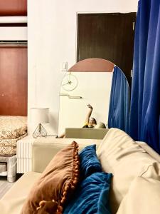a person laying on a bed in a room at Near Airport Beach SwimmingPool HotShower NoElevator Plumera Mactan Condo in Lapu Lapu City
