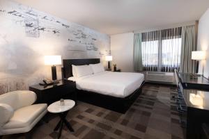 a hotel room with a bed and a couch at Silver Sevens Hotel and Casino, a Wyndham Garden in Las Vegas +24 photos