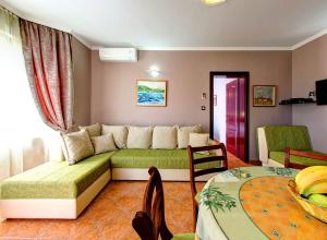 a living room with a couch and a table at Vila Koral in Petrovac na Moru