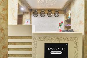 a room with a tumulus store with a sign on the wall at Super Townhouse Kankarbagh Formerly Kunwar Alcajars in Patna