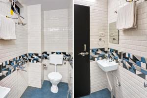 a bathroom with a toilet and a sink at Super Townhouse Kankarbagh Formerly Kunwar Alcajars in Patna