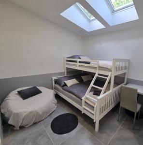 a bedroom with two bunk beds and a desk at Apartman Yasmin Drienica in Drienica