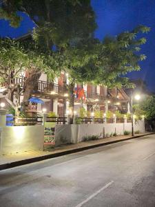 a street in front of a building at night at Luang Prabang Golden Lotus Villa River View in Luang Prabang +60 photos
