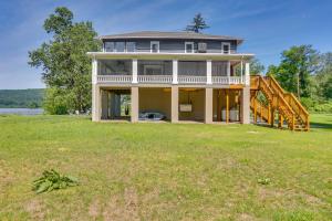 a large house with a large grassy field at Steps to Susquehanna River Hot Tub Hideaway! in Dauphin