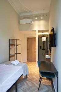 a bedroom with a bed and a chair and a desk at Ella Hostel Boqueria in Barcelona +73 photos