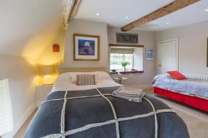 a bedroom with a large bed in a room at Church End Cottage in Milton Keynes