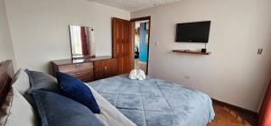 a bedroom with a bed and a couch and a tv at Mirador Calle Larga - anti-ruido in Cuenca