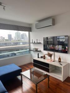 a living room with a couch and a coffee table at Foster Yacht Suites in Buenos Aires