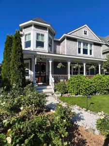 a large white house with a porch at Beach Haven Belle -OI Collection in Beach Haven