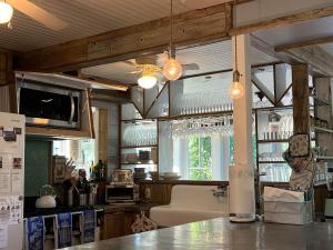 a kitchen with a table and a ceiling at Beach Haven Belle -OI Collection in Beach Haven