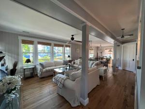 a living room with white couches and a table at Beach Haven Belle -OI Collection in Beach Haven