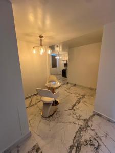 an empty room with a toilet on a marble floor at 1912 Boutique Hotel in Cayey +6 photos