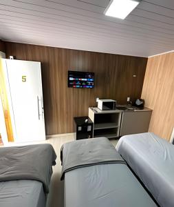 Televisyen dan/atau pusat hiburan di Loft Lux 5 (Smart TV, Ar condicionado, Cozinha...)
