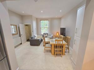 a living room with a table and a couch at Exquisite 2 Bedroom Apartment in Sheffield