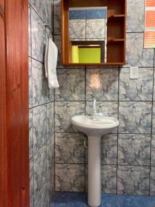 a bathroom with a sink and a mirror at Recanto da Paz - Vale da Prata in Bocaina de Minas