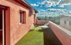 a balcony with a table and chairs on a building at 4 Bedroom Beautiful Home In Rognac in Rognac