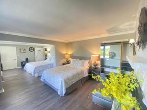 a bedroom with two beds and a window at Butterfly Manor in Niagara Falls