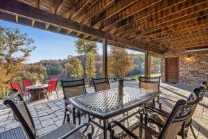 a table and chairs on a patio with a view at The Bunkhouse at Rock Canyon in Branson