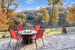 un patio con mesa y sillas y vistas al río en The Bunkhouse at Rock Canyon, en Branson