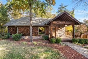 Casa de madera con porche y terraza en The Cabin at Rock Canyon, en Branson