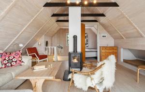 a living room with a couch and a wood stove at 5 Bedroom Awesome Home In Vestervig in Vestervig