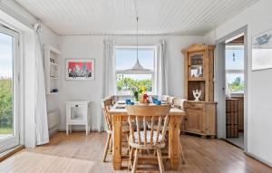 a kitchen and dining room with a table and chairs at 5 Bedroom Awesome Home In Vestervig in Vestervig