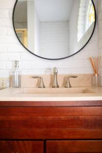 a bathroom with a sink and a mirror at Captains Courtyard - Heart of Historic Downtown Wilmington - 48 Firepit - Turf Yard in Wilmington +26 photos