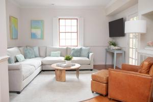 a living room with a couch and a table at 48" Gas Firepit - Historic DT - Late Summer Specials - Steps to Riverwalk in Wilmington