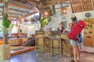 a woman standing at a counter in a restaurant at Soffta Surf Ranch in General Luna