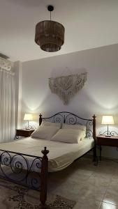 a bedroom with a bed with two lamps and two tables at فيلا خاصة بمنتجع هوليداي ان فانتازيا - راس سدر باطلالة على البحر in Ras Sedr +217 photos