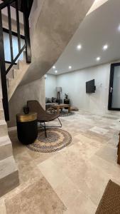 a living room with a staircase and a chair and a couch at LODGE ESCOVIEN Strasbourg in Eschau +24 photos