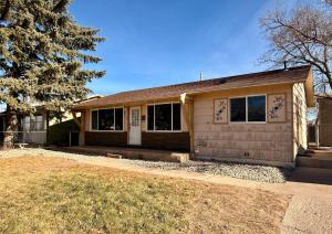 a home with a brown house with a tree at Comfortable Family Getaway! in Cheyenne