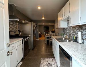 a kitchen with white cabinets and a counter top at Comfortable Family Getaway! in Cheyenne
