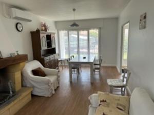 a living room with a couch and a table and chairs at Maison avec Jardin près du Lac de Gastes - 6 pers, Ménage inclus, Idéale Familles - FR-1-319-407 in Gastes +7 photos