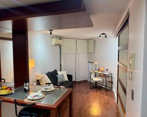 a small apartment with a kitchen and a living room at Alto Depto Merced 562 in Santiago