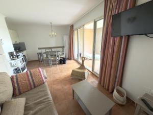 a living room with a couch and a table at Appartement climatisé en Provence, à deux pas du Golf de Pont Royal - FR-1-658-35 in Mallemort