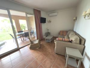 a living room with a couch and a table at Appartement climatisé en Provence, à deux pas du Golf de Pont Royal - FR-1-658-35 in Mallemort +12 photos