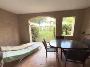 a room with a table and a bed and a table and chairs at Appartement climatisé en Provence, à deux pas du Golf de Pont Royal - FR-1-658-35 in Mallemort
