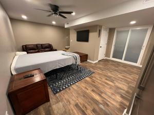 a bedroom with a bed and a ceiling fan at Charming Renovated Home Near Fayetteville, Rustic Retreat for Families in Raeford +7 photos