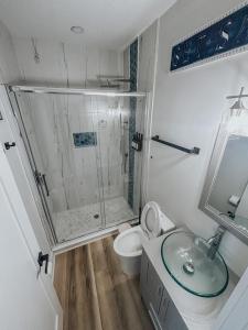 a bathroom with a shower and a toilet and a sink at The Bosun Locker at Seahorse Rentals in Jacksonville Beach