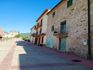 un edificio in pietra con porte blu su una strada di Rustic Home in Mieres near Banyoles Lake a Mieres
