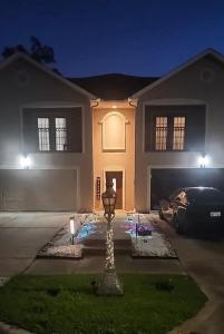 a house with a car parked in front of it at Bring the Crew! 4BR Luxe Pad, Backyard Magic & City at Your Door in Houston