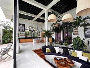 a living room with a couch and a table at The Castle Uluwatu - Ocean View Luxury villa in Uluwatu