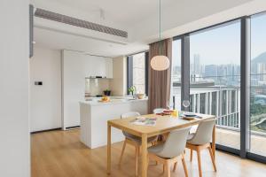 a kitchen and dining room with a table and chairs at Stey Shenzhen Qianhai Hotel in Shenzhen