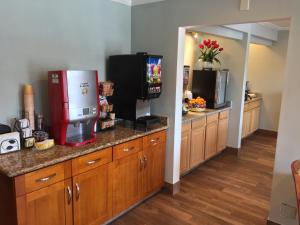 a kitchen with a television and a refrigerator at Regency Inn at San Francisco Airport in San Bruno