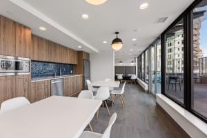an office with white tables and chairs and windows at Beach Lake Resort in Kelowna
