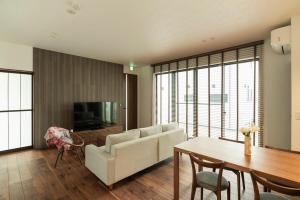 a living room with a couch and a table at MOVA VILLA Koshi Daiwa 3 in Yuge