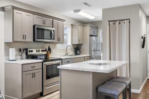 a kitchen with white cabinets and a counter top at Modern Comfort Retreat in Branson